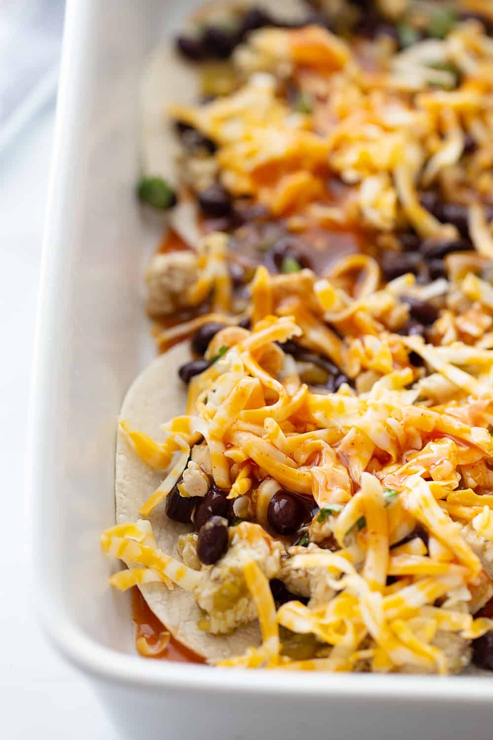 Layered Black Bean Enchiladas - When you don't have the time for classic chicken enchiladas, try these layered black bean enchilads. Quick, easy, and delicious! #enchiladas #mexicanrecipe #mexicanfood #blackbean #halfscratched #tacotuesday #easyrecipe #enchilada