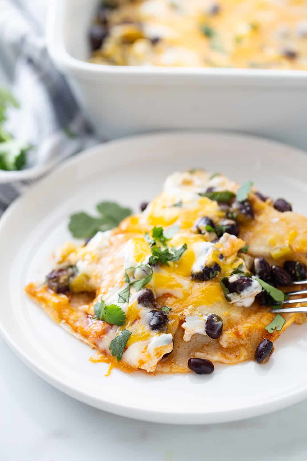 Layered Black Bean Enchiladas - When you don't have the time for classic chicken enchiladas, try these layered black bean enchilads. Quick, easy, and delicious! #enchiladas #mexicanrecipe #mexicanfood #blackbean #halfscratched #tacotuesday #easyrecipe #enchilada