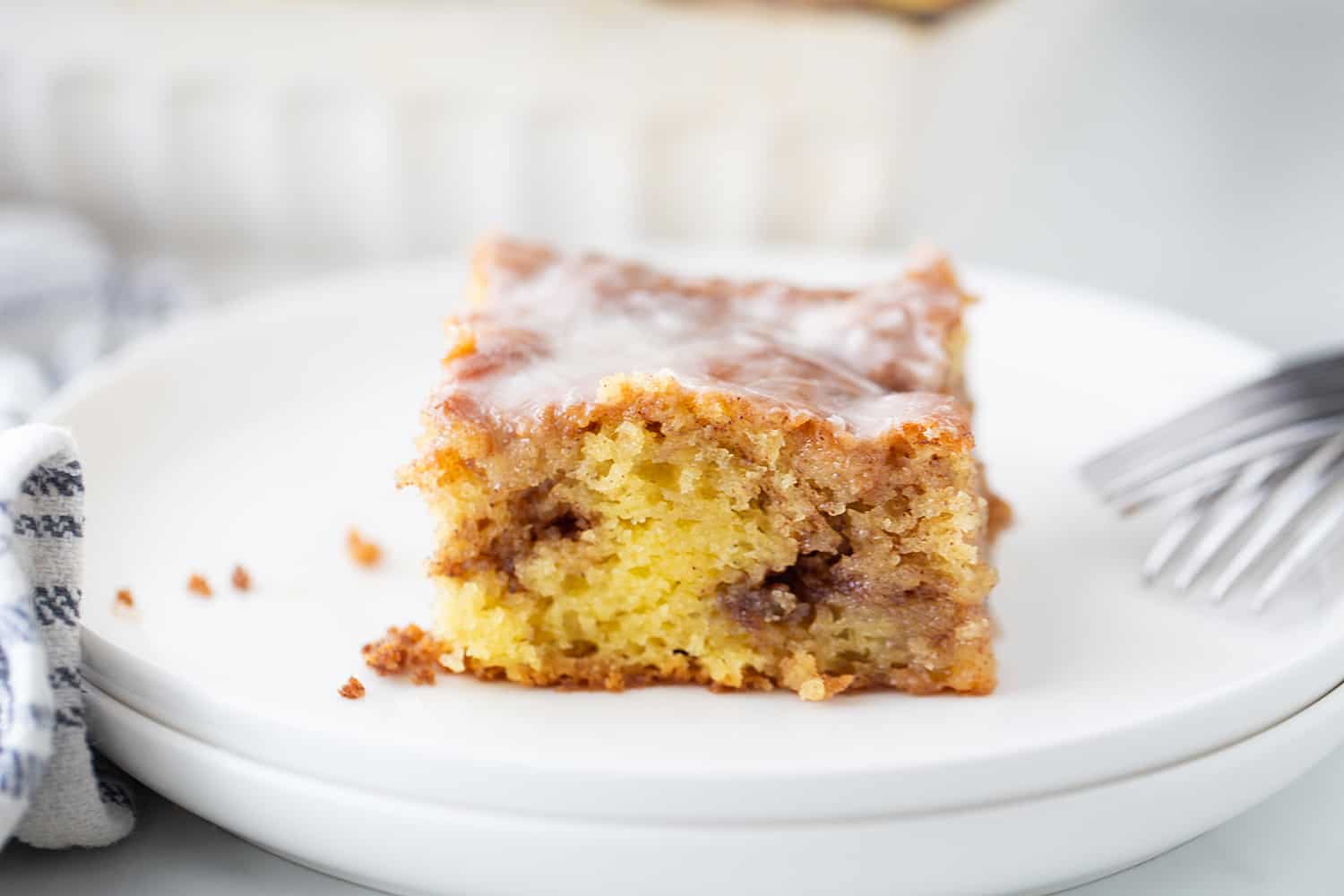 One slice of Honey Bun Cake on a plate.