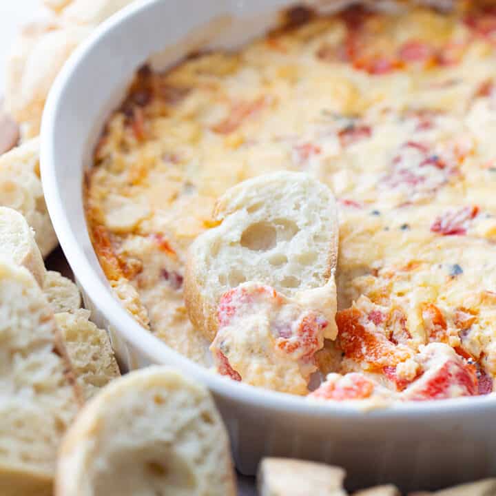 Hot Roasted Red Pepper Dip - Planning a summer staycation? #ad Make sure to add some hot roasted red pepper dip to the schedule. In fact, it's so good, you'll want to list it twice! The rich, smoky flavor of @Mezzetta roasted red peppers take this creamy, cheesy, flavorful dip to an entirely new level—a totally tasty, gotta-have-it level! #Mezzetta #halfscratched #hotdip #hotappetizer #appetizer #baking #cooking #vegetarian