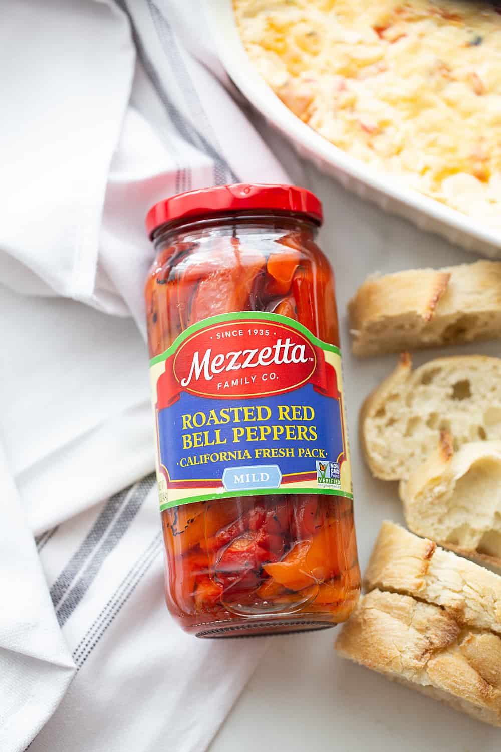 Hot Roasted Red Pepper Dip - Planning a summer staycation? #ad Make sure to add some hot roasted red pepper dip to the schedule. In fact, it's so good, you'll want to list it twice! The rich, smoky flavor of @Mezzetta roasted red peppers take this creamy, cheesy, flavorful dip to an entirely new level—a totally tasty, gotta-have-it level! #Mezzetta #halfscratched #hotdip #hotappetizer #appetizer #baking #cooking #vegetarian