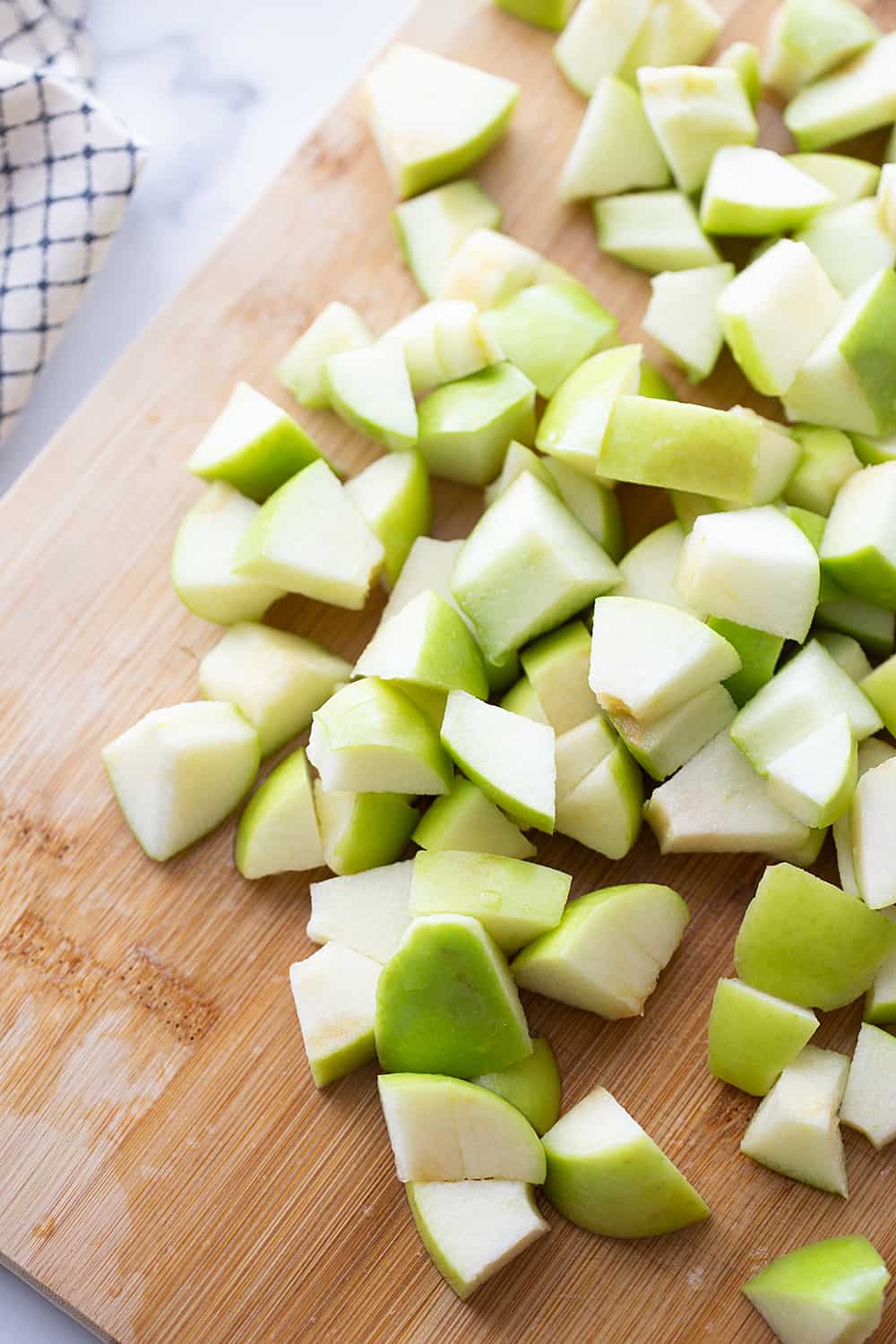 Easy Snickers Salad - This easy Snickers salad features Granny Smith apples, Snickers, and whipped topping with a drizzle of caramel and a sprinkle of toffee bits. #snickers #salad #dessert #halfscratched #easyrecipe #dessertsalad #sweets