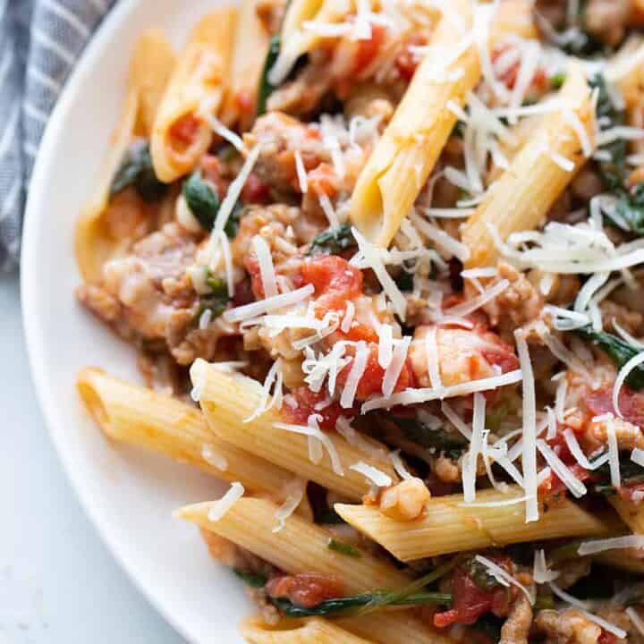 Tomato and Spinach Pasta Toss - With this easy tomato and spinach pasta toss recipe in your rotation, you can have a delicious, hearty meal ready in minutes! #pasta #italianfood #halfscratched #tomato #spinach #pastarecpie #maindish