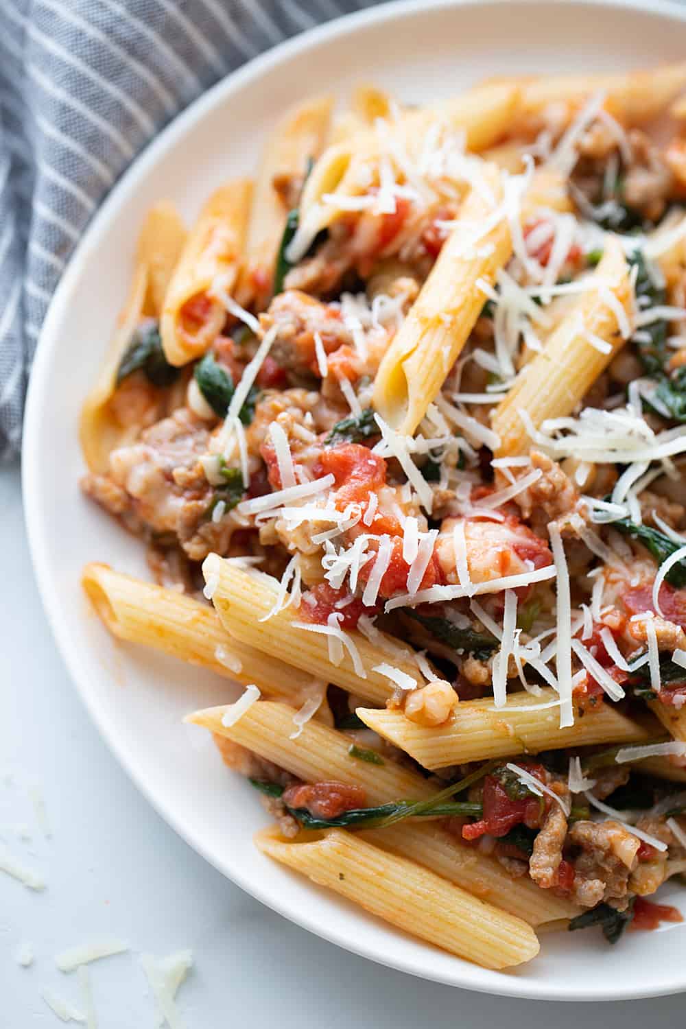 Tomato and Spinach Pasta Toss - With this easy tomato and spinach pasta toss recipe in your rotation, you can have a delicious, hearty meal ready in minutes! #pasta #italianfood #halfscratched #tomato #spinach #pastarecpie #maindish