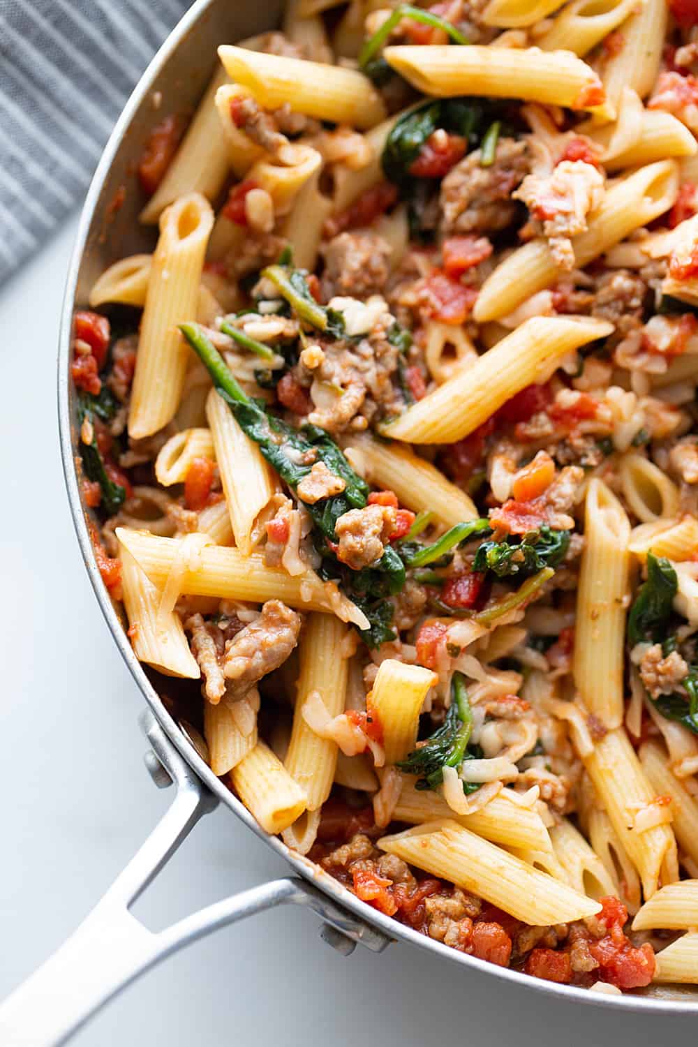 Tomato and Spinach Pasta Toss - With this easy tomato and spinach pasta toss recipe in your rotation, you can have a delicious, hearty meal ready in minutes! #pasta #italianfood #halfscratched #tomato #spinach #pastarecpie #maindish