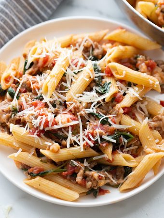 Tomato and Spinach Pasta Toss - With this easy tomato and spinach pasta toss recipe in your rotation, you can have a delicious, hearty meal ready in minutes! #pasta #italianfood #halfscratched #tomato #spinach #pastarecpie #maindish