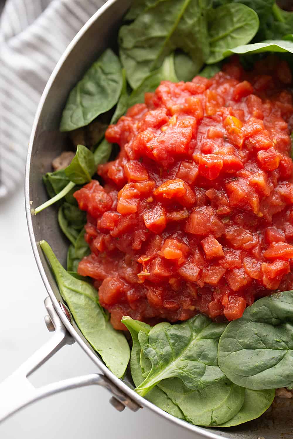 Tomato and Spinach Pasta Toss - With this easy tomato and spinach pasta toss recipe in your rotation, you can have a delicious, hearty meal ready in minutes! #pasta #italianfood #halfscratched #tomato #spinach #pastarecpie #maindish