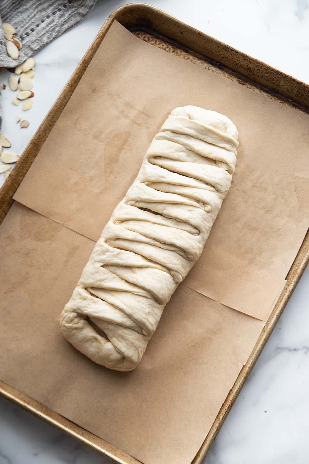 Easy Almond Braid - This easy almond braid is simple *and* totally scrumptious. Good luck not eating the entire beautifully braided dessert in one sitting! #halfscratched #dessert #brunch #almond #almonddessert #baking #almondbraid #braideddessert #recipe #dessertrecipe