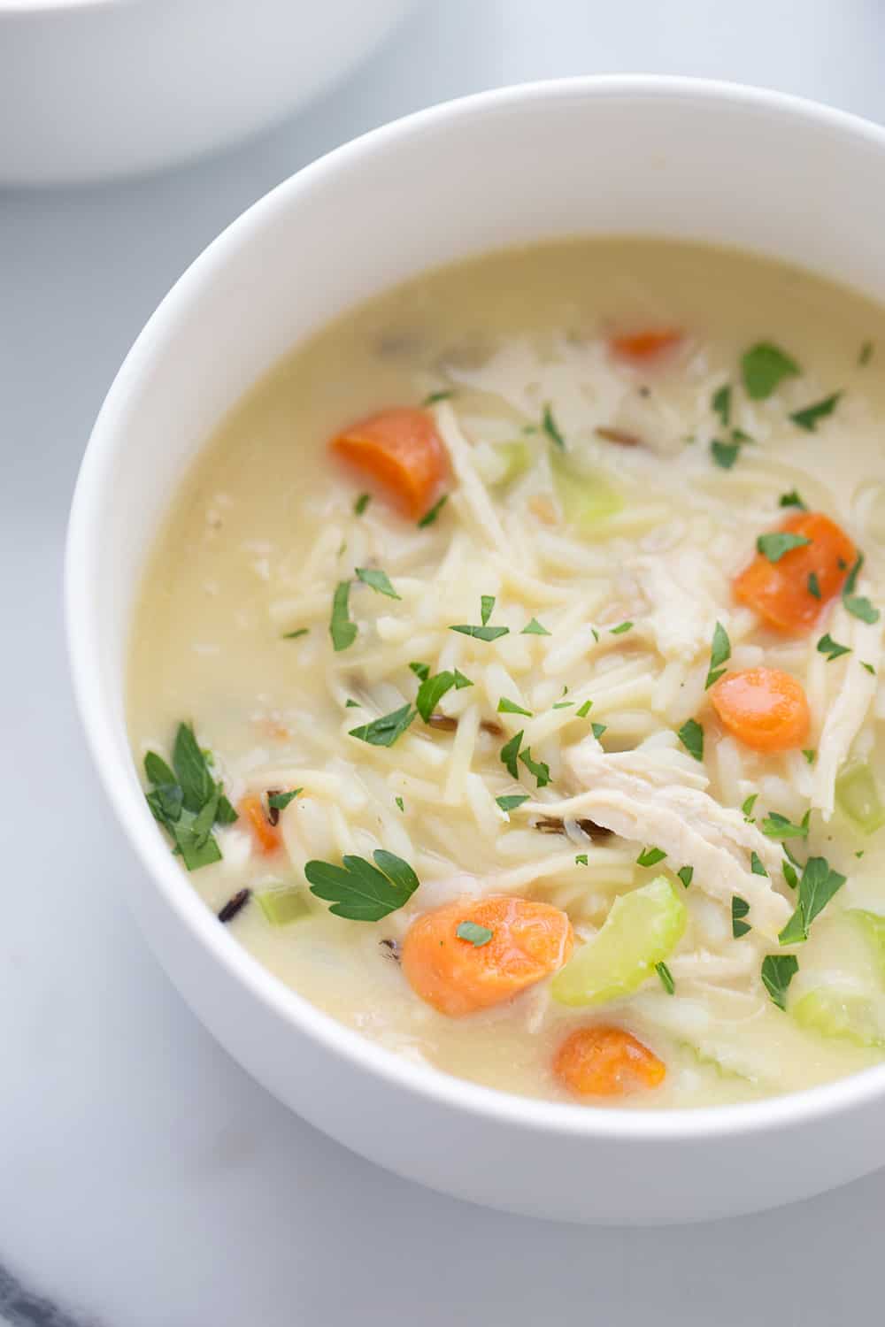 Easy Creamy Chicken Noodle and Rice Soup - Need a comforting weeknight meal that's also quick and easy? Give this creamy chicken noodle and rice soup a try! #soup #chickensoup #chickennoodlesoup #easyrecipe #halfscratched #maindish #easysoup #souprecipe