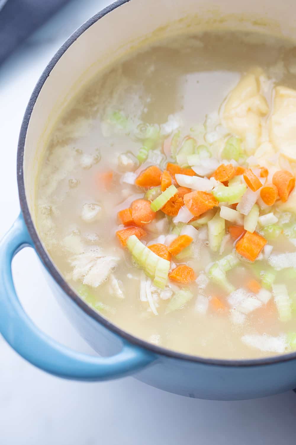 Easy Creamy Chicken Noodle and Rice Soup - Need a comforting weeknight meal that's also quick and easy? Give this creamy chicken noodle and rice soup a try! #soup #chickensoup #chickennoodlesoup #easyrecipe #halfscratched #maindish #easysoup #souprecipe