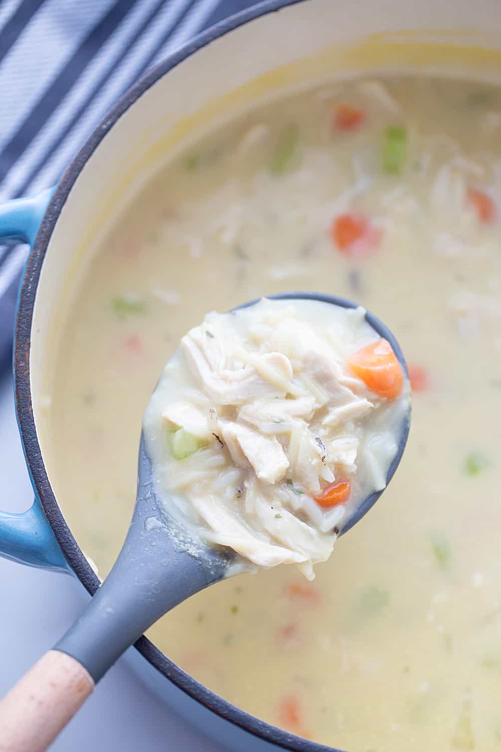 Easy Creamy Chicken Noodle and Rice Soup - Need a comforting weeknight meal that's also quick and easy? Give this creamy chicken noodle and rice soup a try! #soup #chickensoup #chickennoodlesoup #easyrecipe #halfscratched #maindish #easysoup #souprecipe