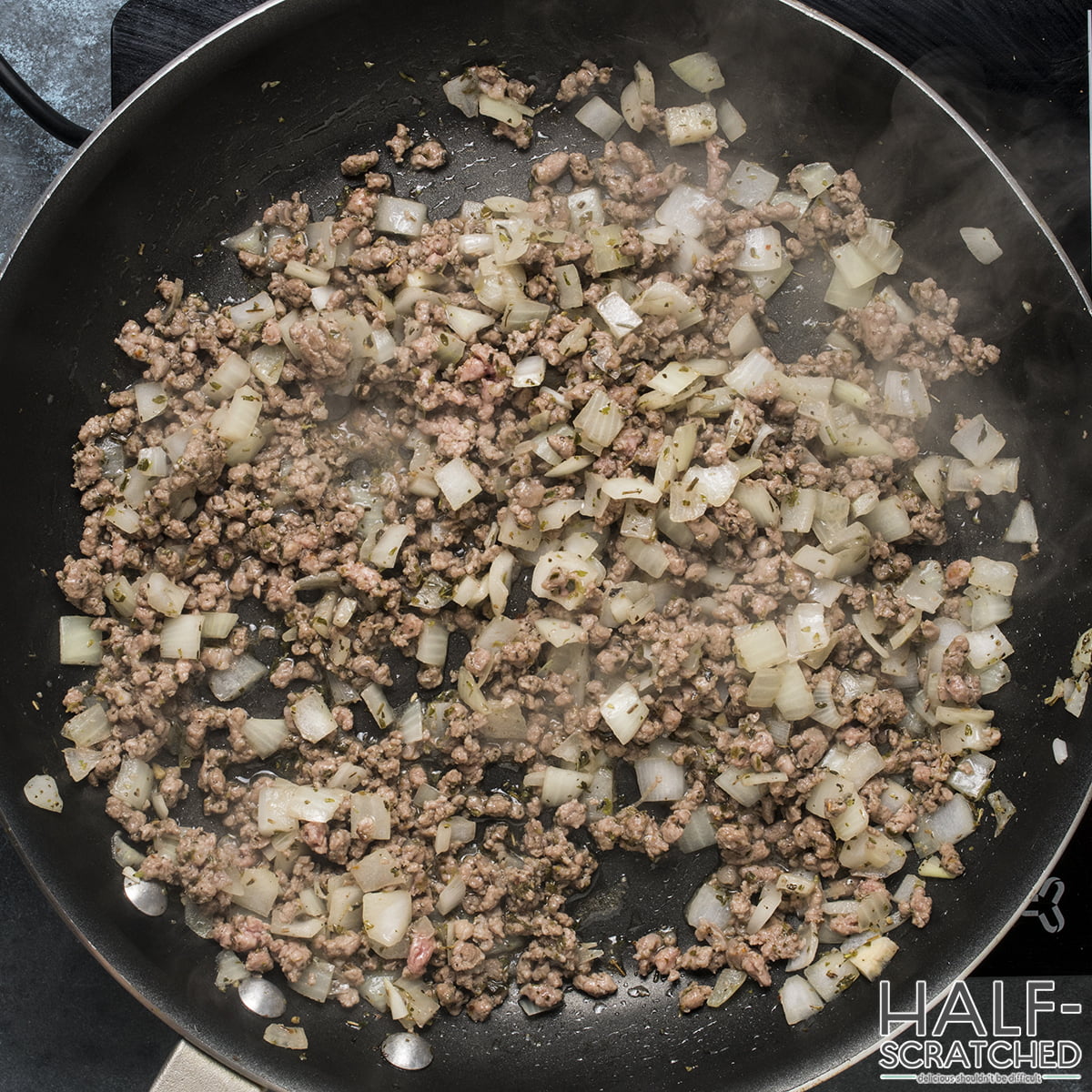 Meat and onion in a frying pan