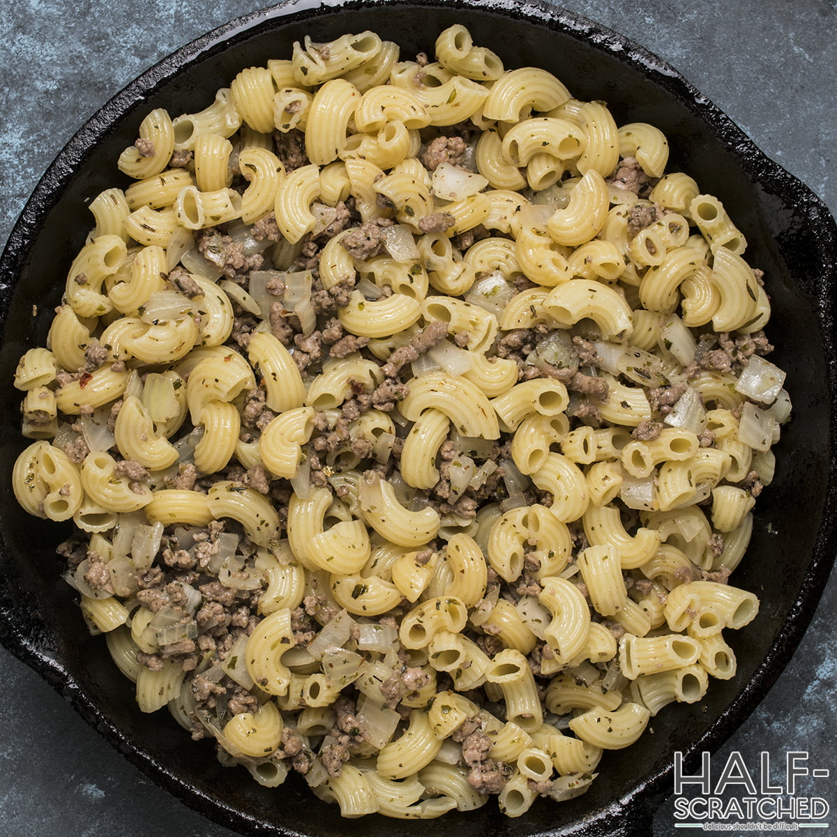 Adding Macaroni with onions and meat