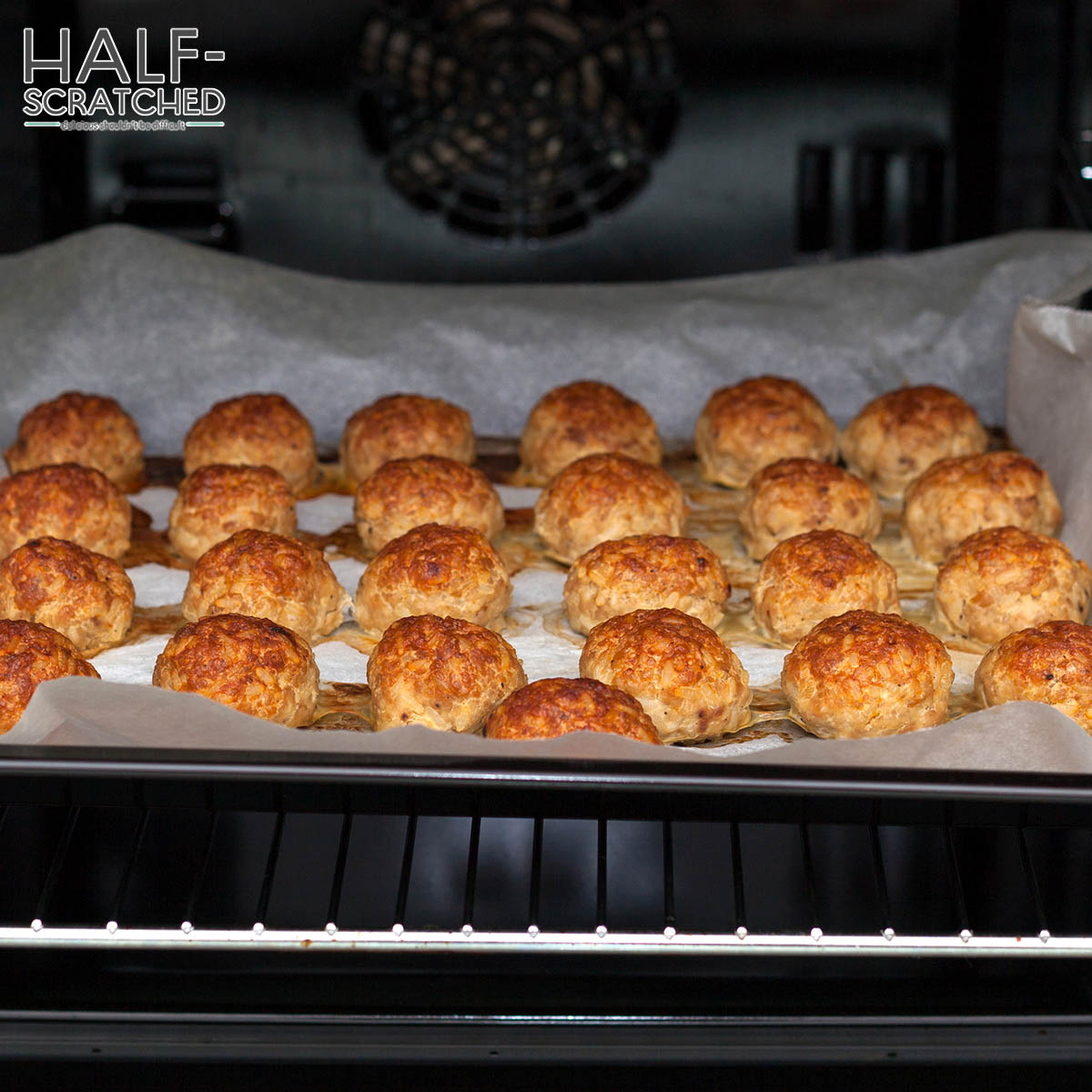 Meatballs in the oven on a tray