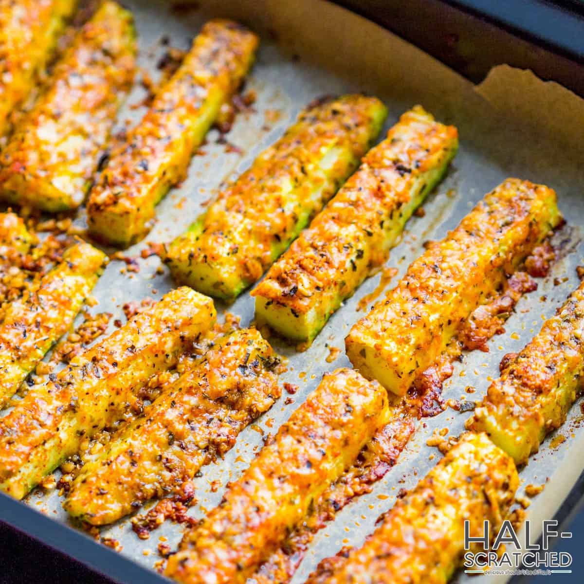 Breaded zucchinis on a baking tray