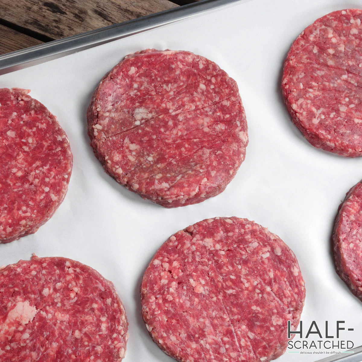 Burger patties on a baking tray