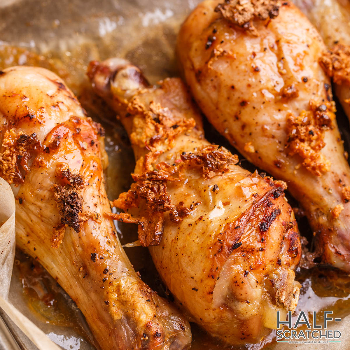 Baked chicken thighs on an oven tray