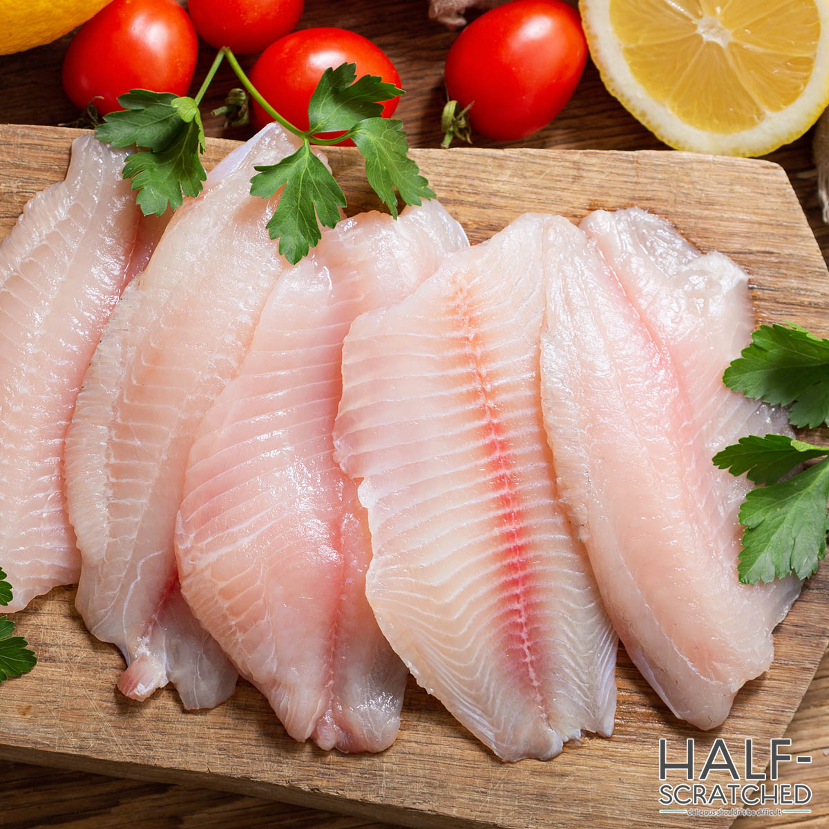 Fresh tilapia fillets before baking