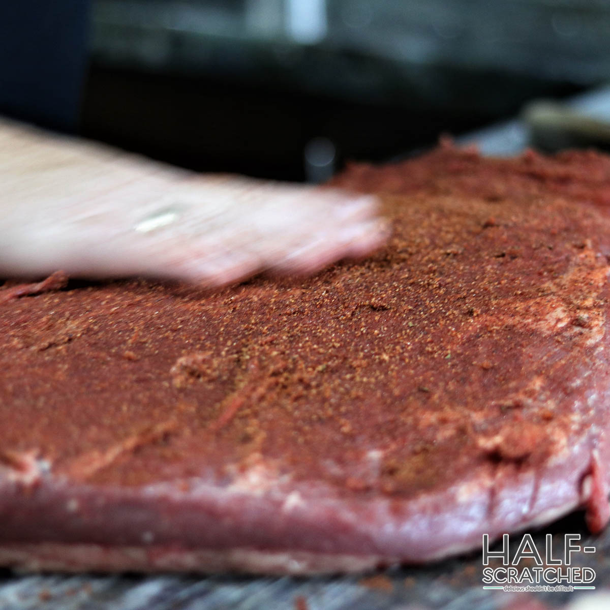 Rubbing seasoning into beef brisket