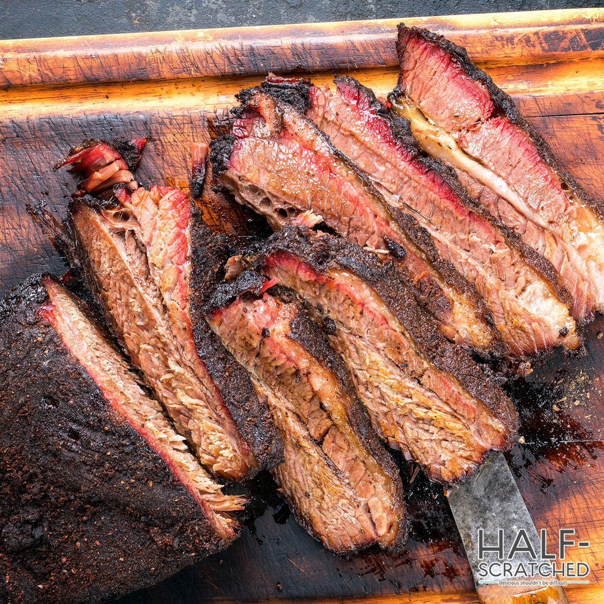 Slived smoked brisket on a cutting board