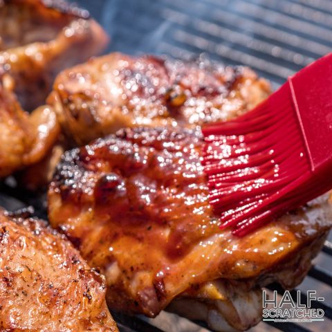 Smoked chicken thighs adding sauce