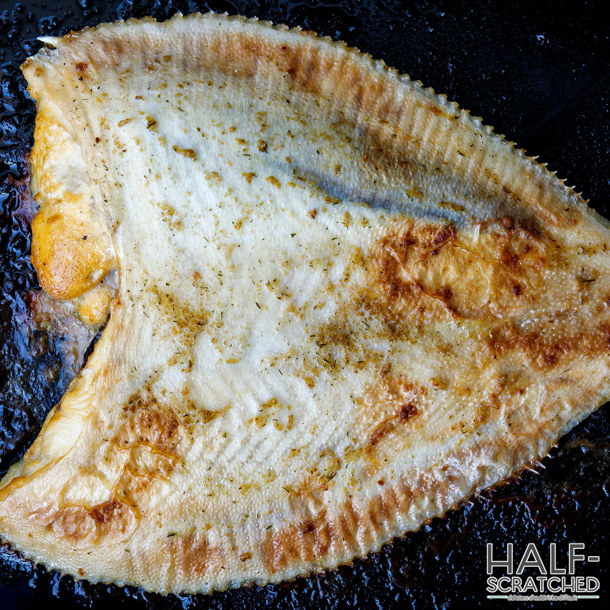 Baked flounder filet on a baking tray