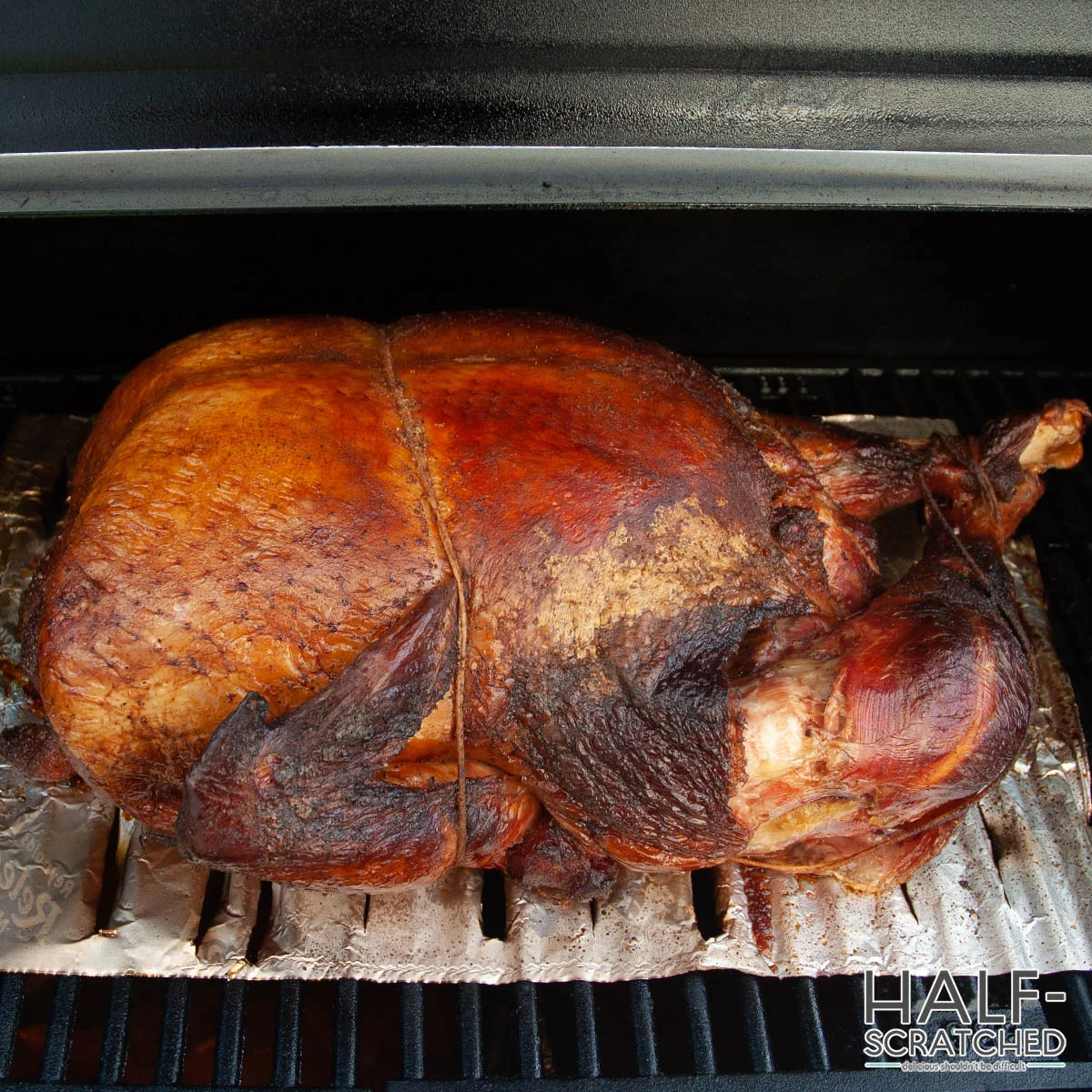 Smoked turkey resting on foil