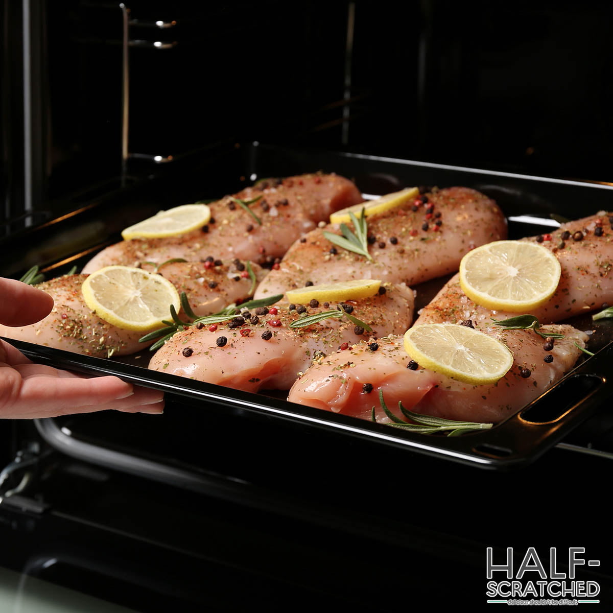 Putting chicken breasts into oven