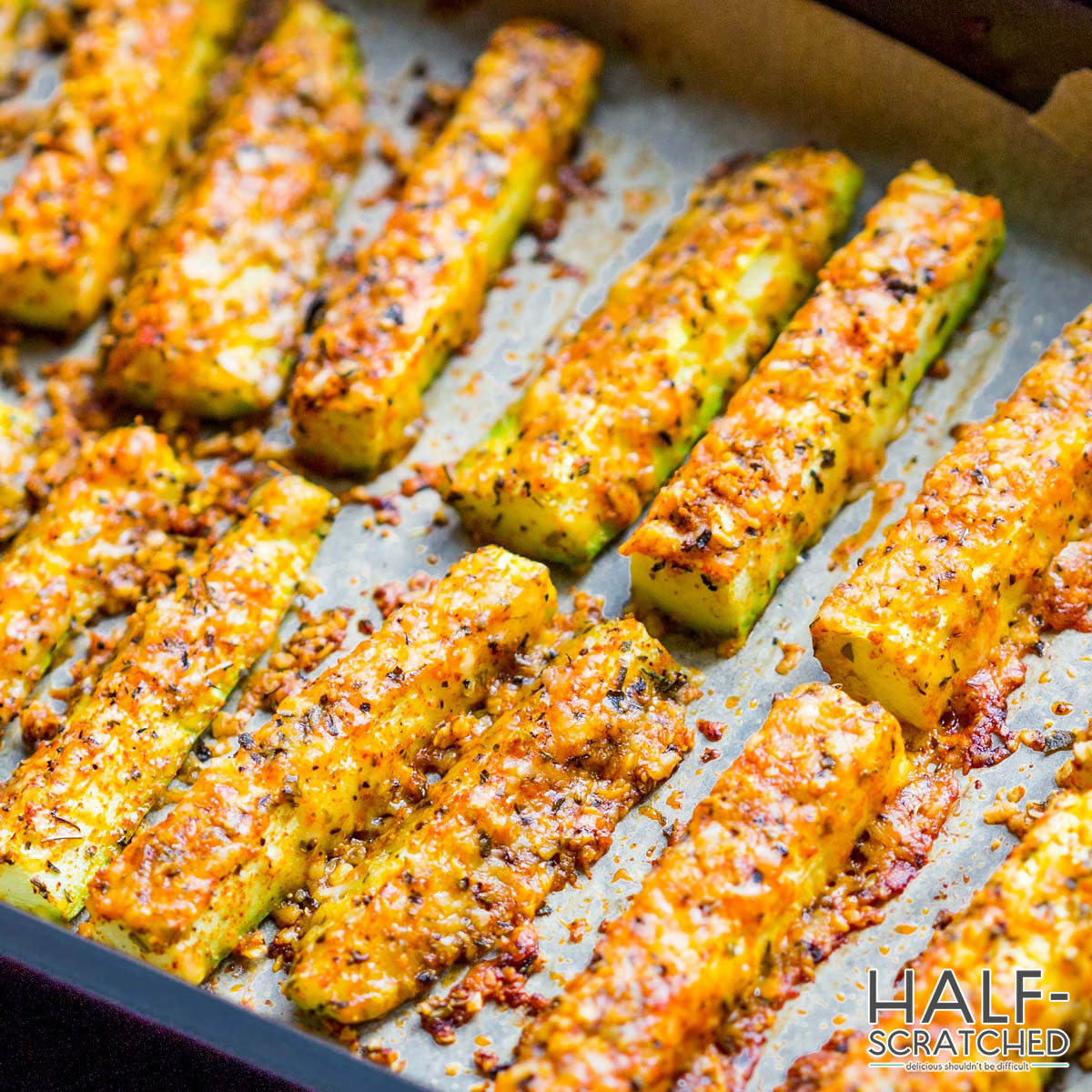 Baked zucchini spears with cheese in the oven