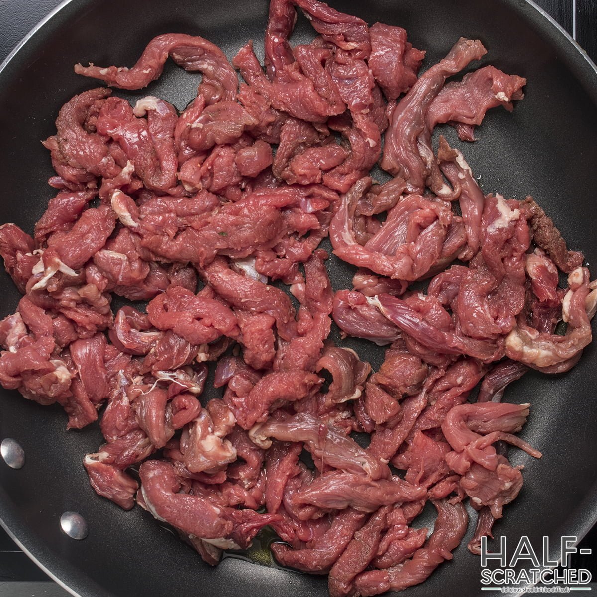 Adding beef to a skillet 