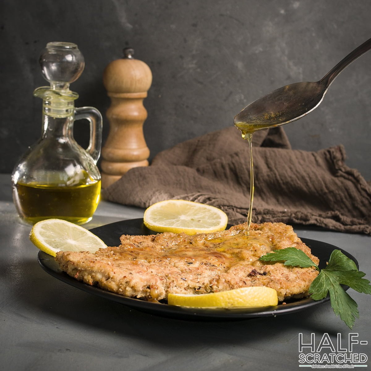 Adding lemon sauce to chicken breast