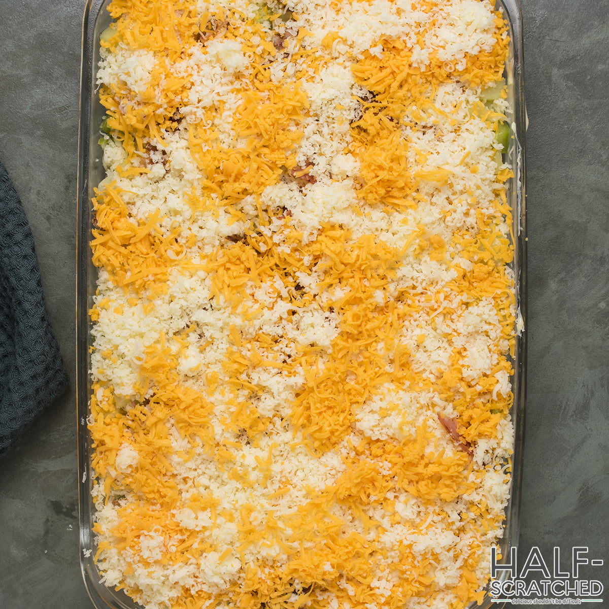 Grated cheese on top of a baking dish