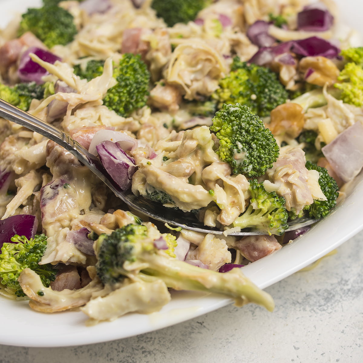 A spoon on a Chicken Salad Chick Broccoli salad