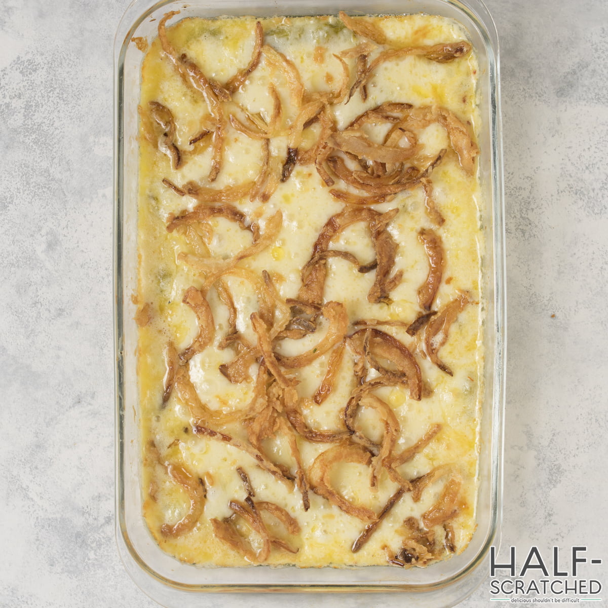 Fried onions on mozzarella in a baking dish
