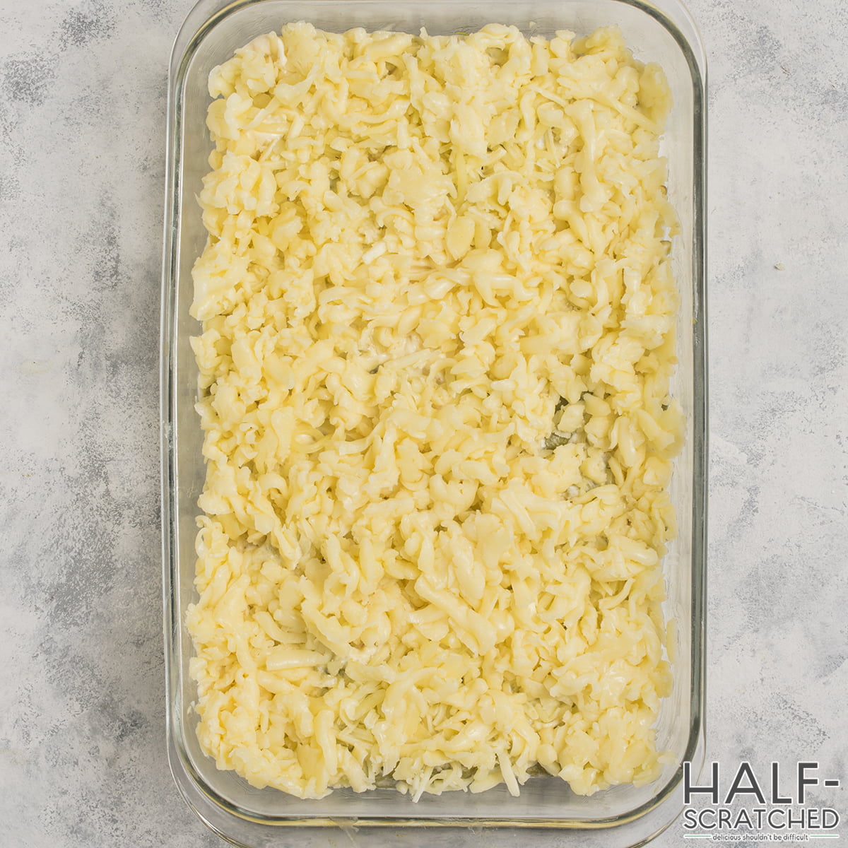 Grated mozzarella cheese on baking dish
