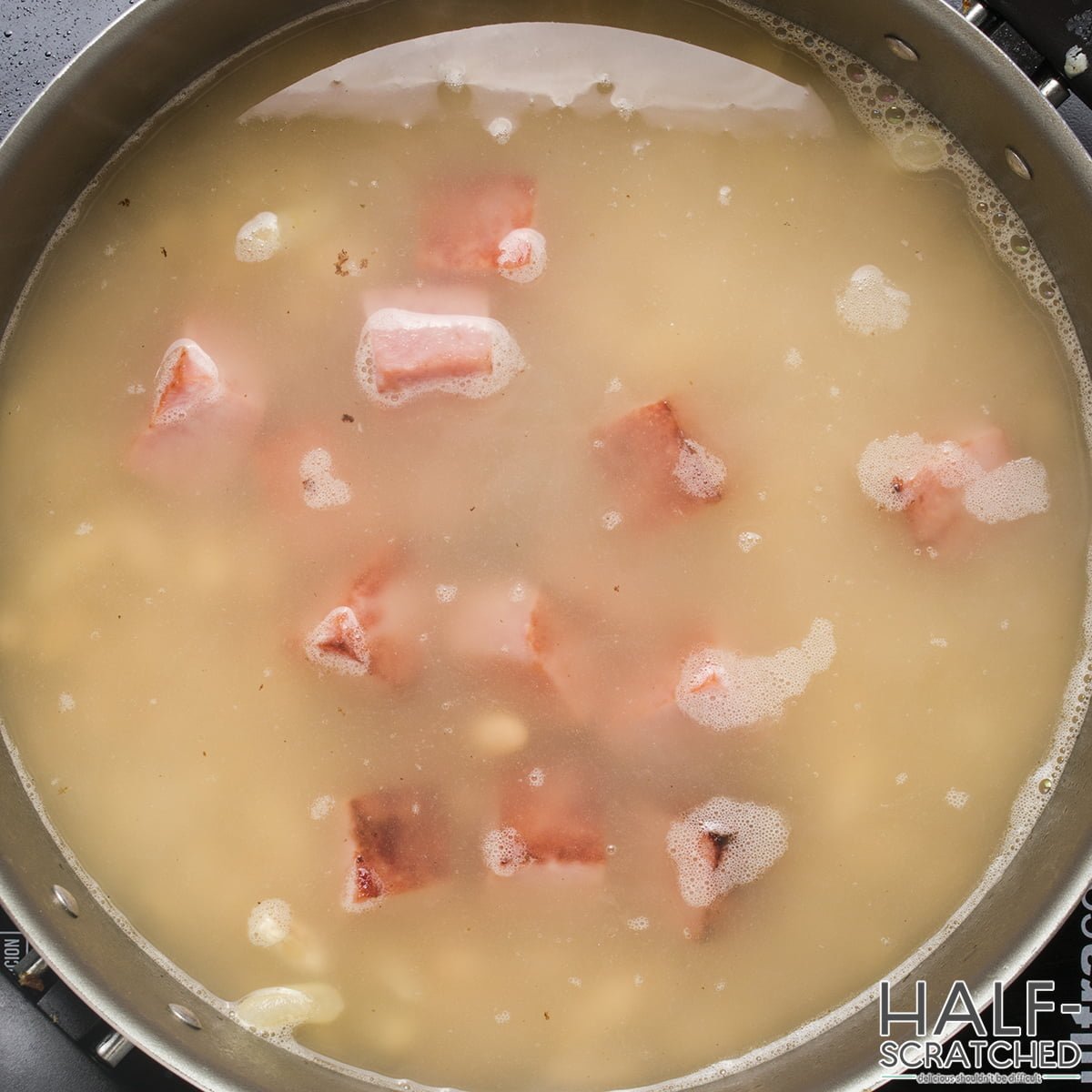 Ham to the beans in a pot