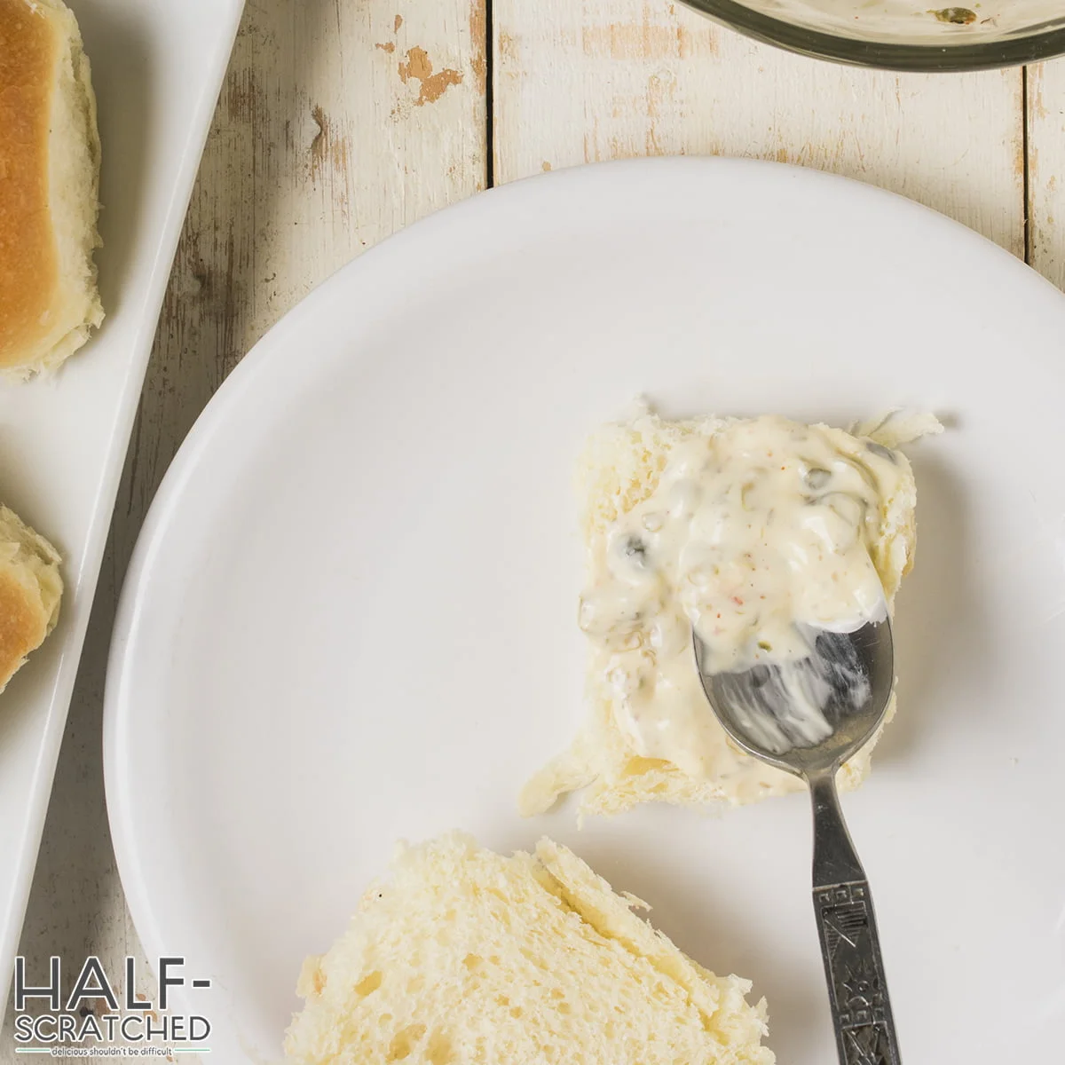 Spreading some of the caper mayo sauce