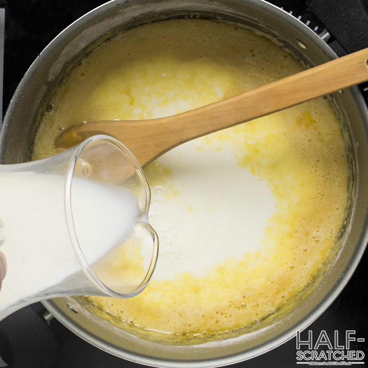 Adding milk to a saucepan