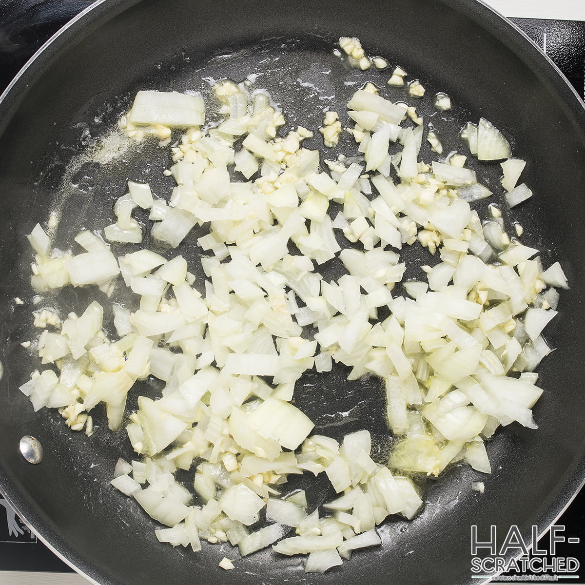 A frying pan with onion and garlic