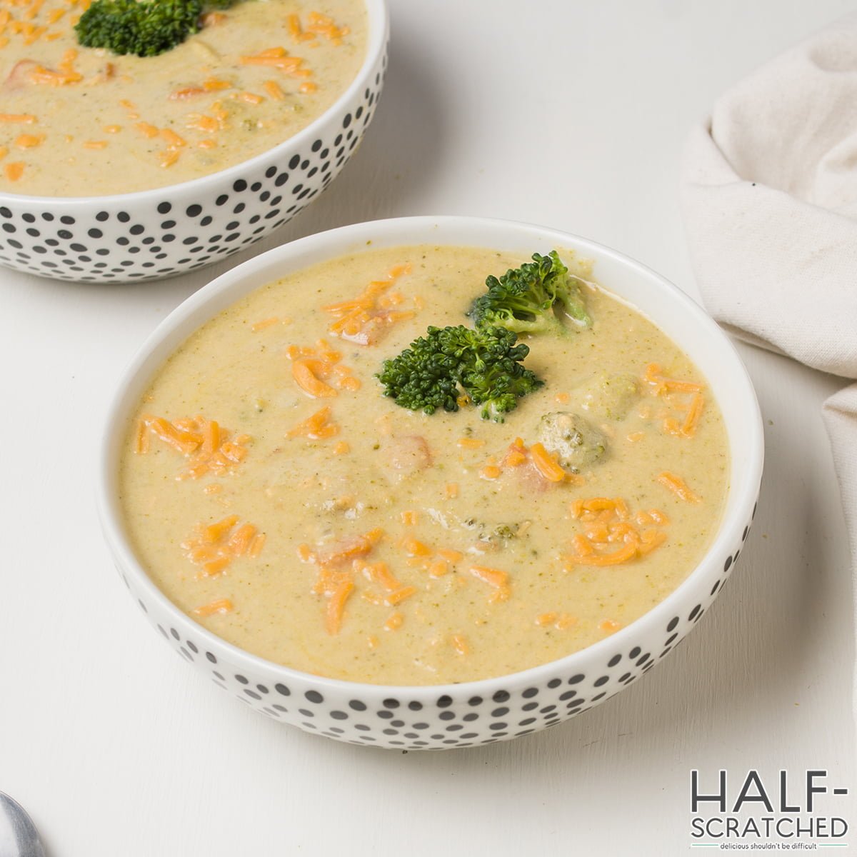 Overview of a bowl with broccoli and cheddar soup