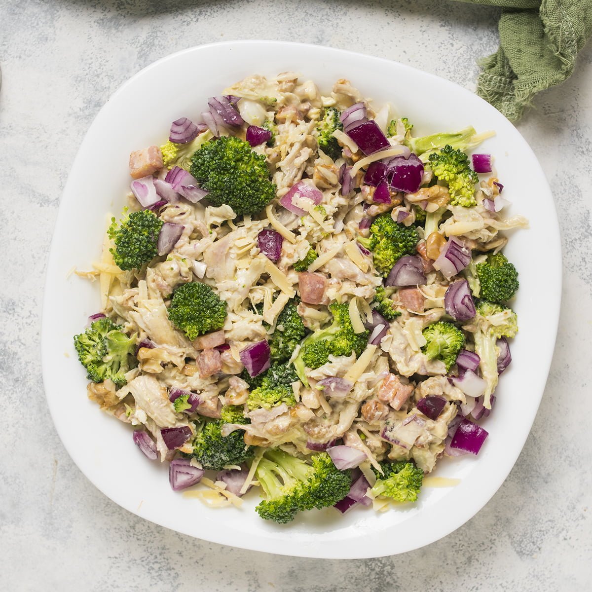 A plate full of chicken and broccoli salad