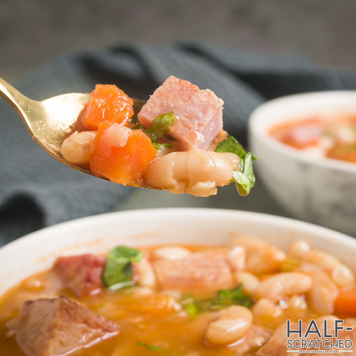 Spoon with ham and bean soup