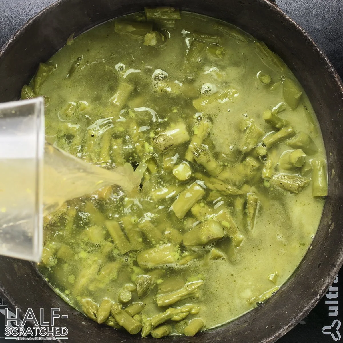 Adding broth to asparagus