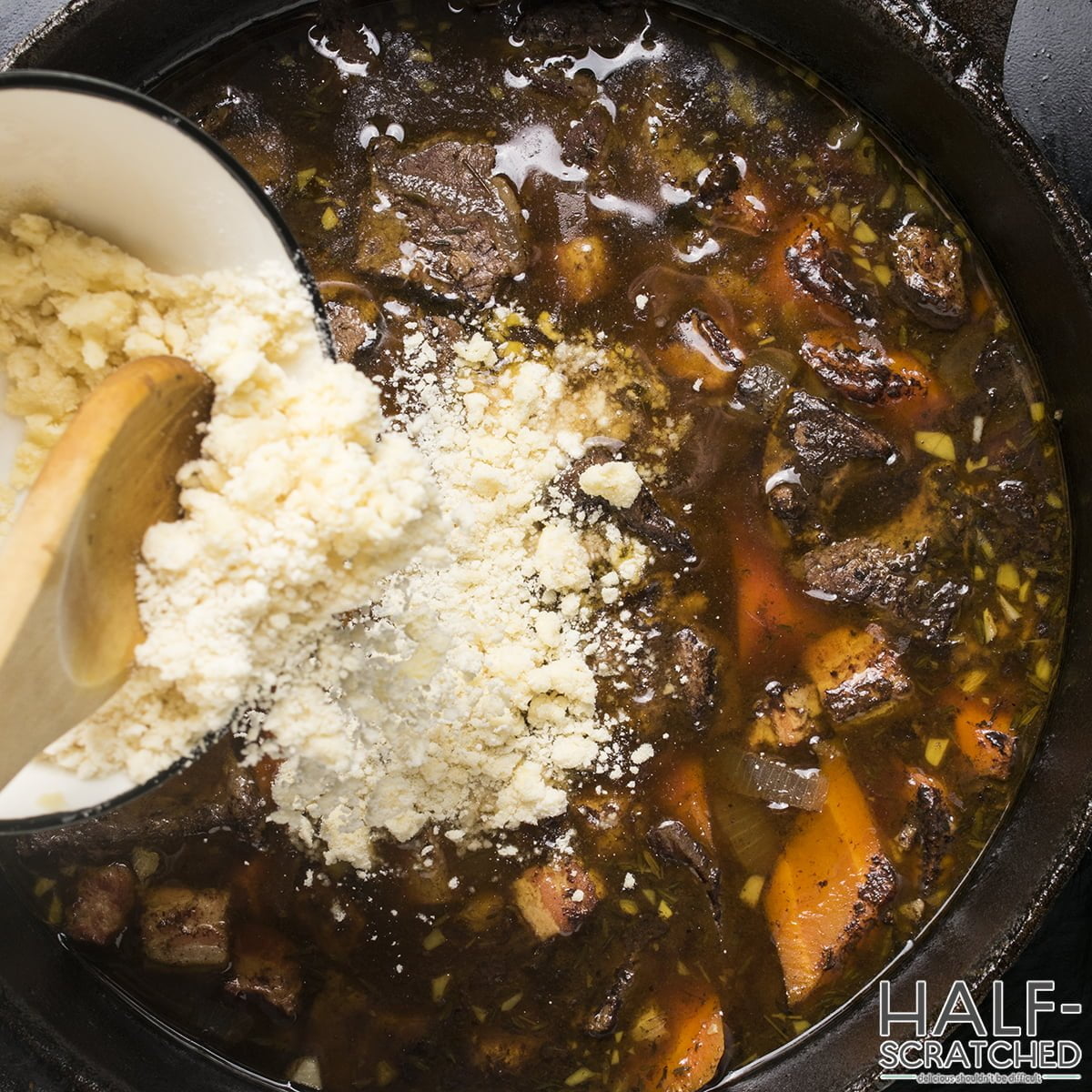 Adding flour to a pot with beef