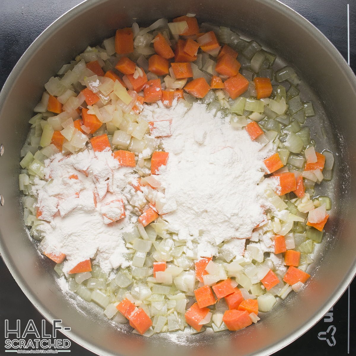 Flour, onion, carrot and garlic in a pot