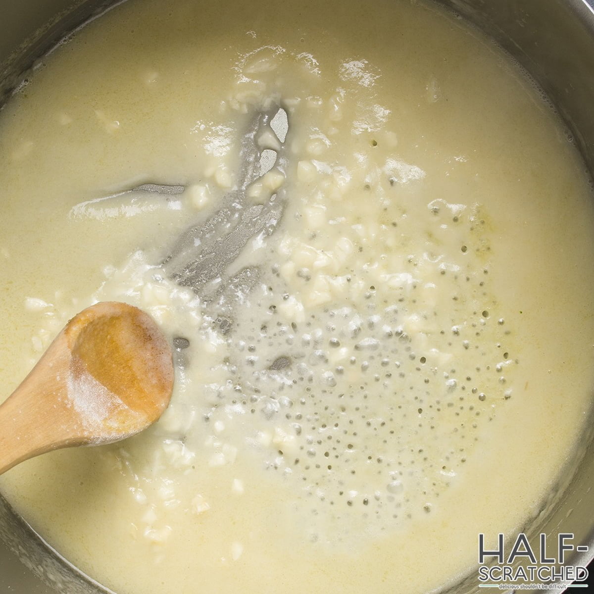 Adding the vinegar, water, garlic, and salt