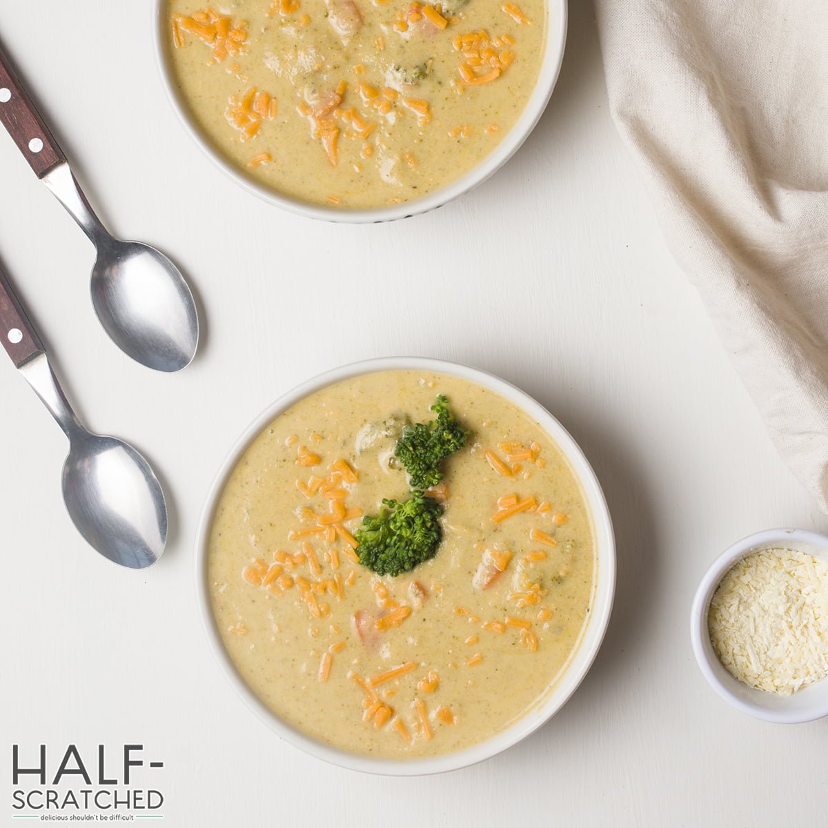 Two bowls with broccoli and cheddar soup