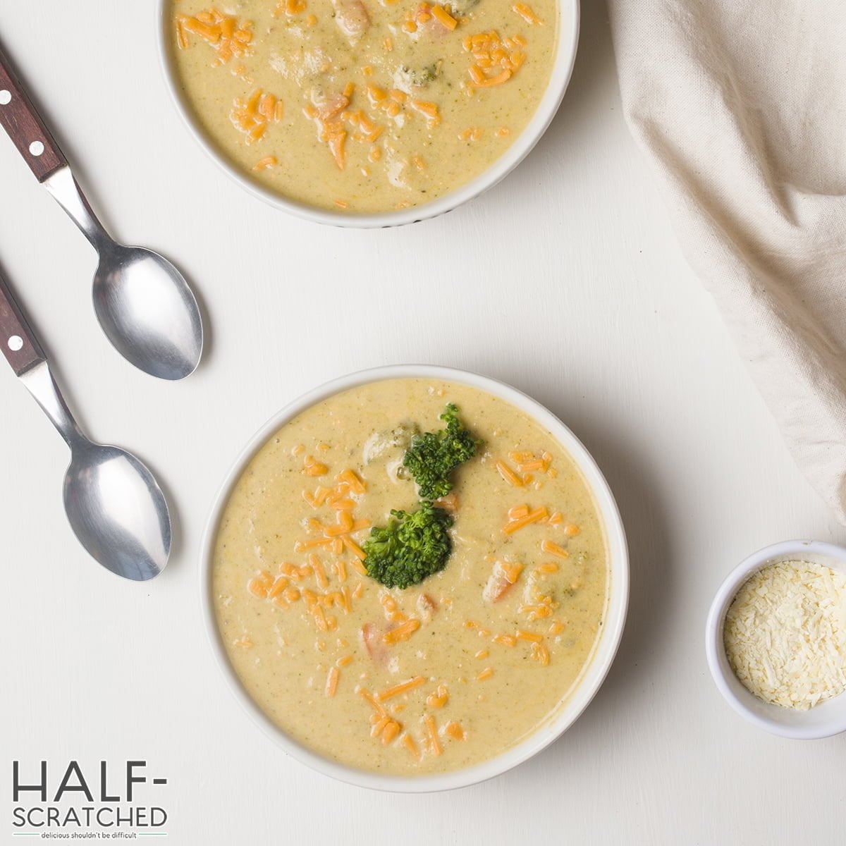 Two bowls with broccoli and cheddar soup