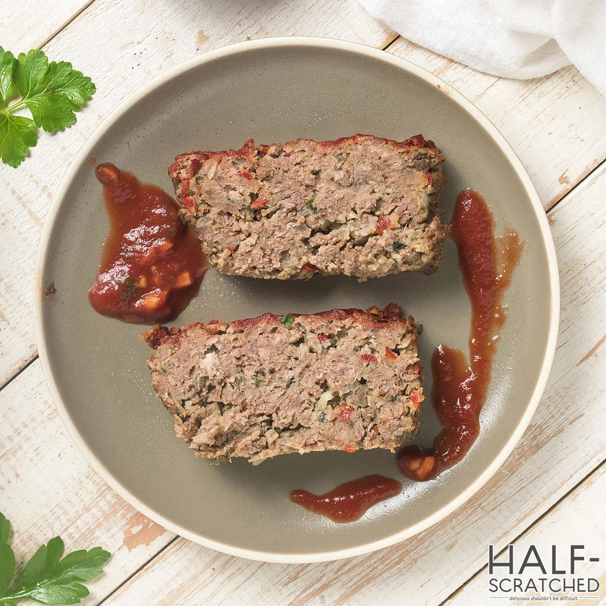 Two portions of meatloaf served on a plate