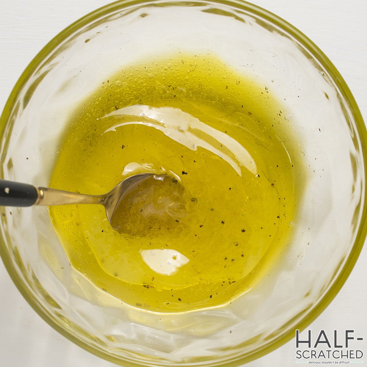 whisking olive oil with the lemon juice